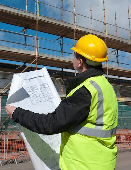 Image of building site and Man in foreground